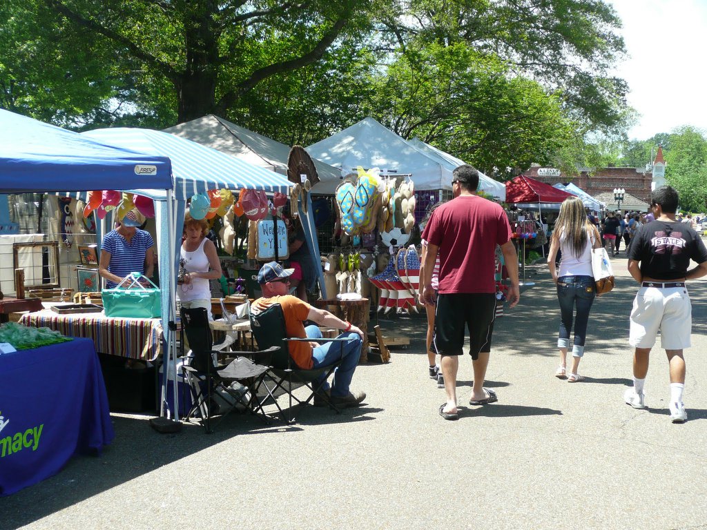 Guests walking by tents at Collierville Fair on the Square arts and crafts festival